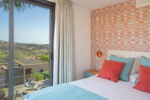 a bedroom with a bed and a large window at Las Terrazas Villa 3 in Salobre +22 photos