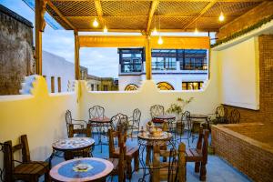 a patio with tables and chairs in a restaurant at Dar Chbili Fès in Fez +79 photos