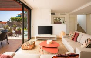 a living room with a couch and a tv at Las Terrazas Villa 3 in Salobre