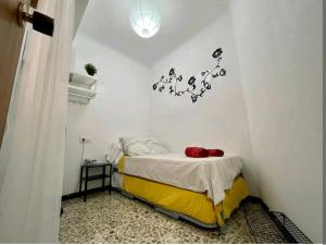 a bedroom with a bed and a light on the wall at Hogar dulce hogar. in Águilas +4 photos
