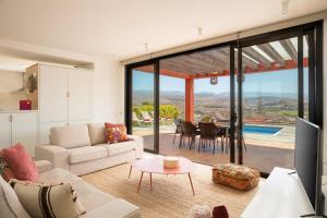 a living room with a couch and a table at Las Terrazas Villa 3 in Salobre