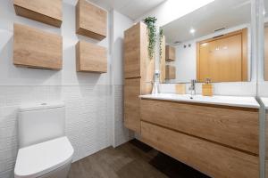 a bathroom with a sink and a toilet at Sunset- Spa and Bbq in Calafell +18 photos