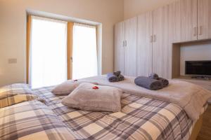 a bedroom with a bed with towels on it at Appartamento Sant'Antoni Fontana in Livigno