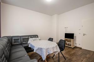 a living room with a couch and a table at Ferienwohnung Alex in Leipzig