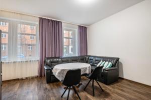 a living room with a couch and a table and chairs at Ferienwohnung Alex in Leipzig