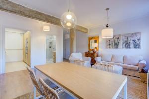 a dining room and living room with a table and chairs at Vivir en Valencia in Valencia +12 photos