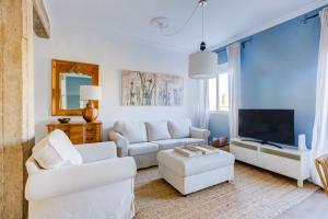a living room with white furniture and a flat screen tv at Vivir en Valencia in Valencia