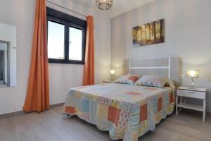 a bedroom with a bed and a window at Casa Toria in Conil de la Frontera +20 photos