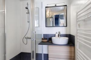 a bathroom with a sink and a mirror at La Pause Iodée - 500 m mer in La Tranche-sur-Mer +15 photos