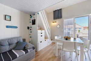 a living room with a couch and a table at La Pause Iodée - 500 m mer in La Tranche-sur-Mer