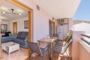 a living room with a table and chairs and a couch at Piso Haza in Haza del Trigo