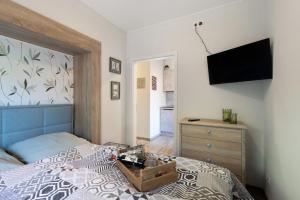 a bedroom with a bed with a tv on the wall at Süsse 2 Zimmerwohnung in Heiligenstedten