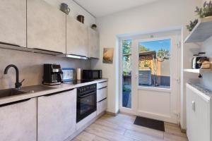 a kitchen with a sink and a stove at Süsse 2 Zimmerwohnung in Heiligenstedten