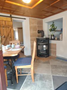 a dining room with a table and a stove at Veronika in Wesenberg +16 photos