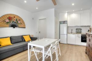 a living room with a couch and a white table at Old Side Platja d Aro in Platja d'Aro