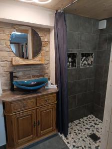 a bathroom with a blue sink and a mirror at Veronika in Wesenberg
