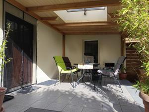 a patio with a table and chairs on it at Veronika in Wesenberg