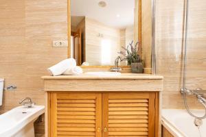 a bathroom with a sink and a mirror at Terraza Larios in Málaga +27 photos