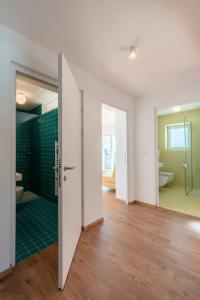 an open bathroom with a shower and a glass door at Hus Appartement - Nr. 5 in Valdaora +12 photos