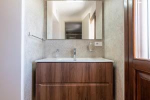 a bathroom with a sink and a mirror at Gma Home Primo Piano in Pulsano +38 photos