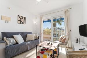a living room with a couch and a table at Sunnygolfbeach in Orihuela Costa
