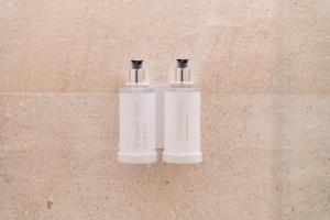 two white bottles are sitting on a wall at Ca Gracia Bocairent in Bocairent