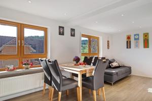 a living room with a table and a couch at Stockerhof in Elzach