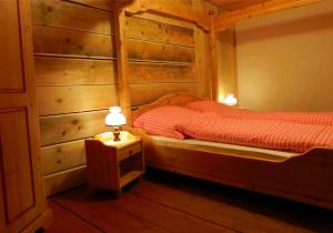 a bedroom with two beds with wooden walls at Schwarzwaldbauernhaus Bernau in Bernau im Schwarzwald