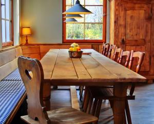 a wooden table with chairs and a bowl of fruit on it at Schwarzwaldbauernhaus Bernau in Bernau im Schwarzwald +20 photos