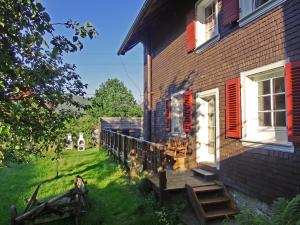 a porch of a house with a wooden stairway at Schwarzwaldbauernhaus Bernau in Bernau im Schwarzwald