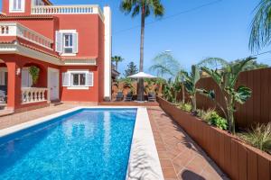 a villa with a swimming pool in front of a house at Casa de Tina in Llucmajor