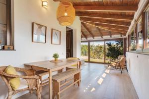 a dining room with a wooden table and chairs at Casa Jica in La Orotava