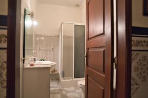 a bathroom with a toilet and a sink and a shower at Casa Pedra da Paciência in Monsanto