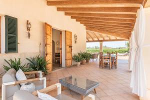 an outdoor patio with a table and chairs at Can Xuri in Campos