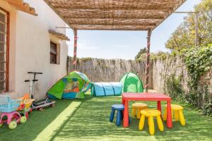 a backyard with a table and chairs and tents at Can Xuri in Campos