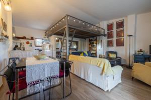 a bedroom with a canopy bed and a dining room at Estudio La Cochera in Deltebre