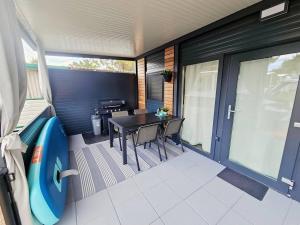 a balcony with a table and chairs on a house at Mobile home Sunset, Privlaka in Privlaka +11 photos
