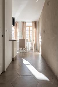 a hallway with a room with a table and a light shining on it at Rennweg 114 BELAMI LIVING in Merano
