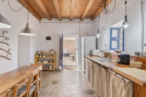 a kitchen with a counter and a refrigerator at Can Vicent in Illes Balears +21 photos