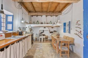 a kitchen with a counter and a table at Can Vicent in Illes Balears