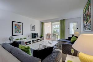 a living room with a couch and a table at Frontline paradise townhouse in Estepona