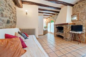 a living room with a couch and a fireplace at Serra de Prades in Montblanc