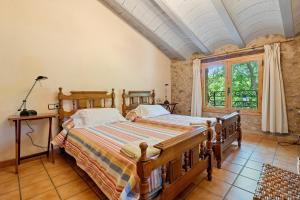 a bedroom with two beds and a window at Serra de Prades in Montblanc +27 photos