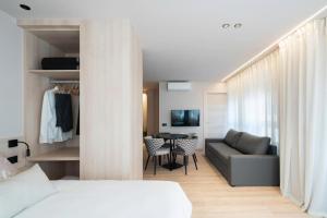 a bedroom with a bed and a couch and a table at Ca Gracia Bocairent in Bocairent