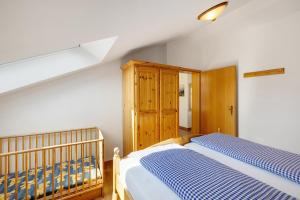 a bedroom with a bed and a wooden cabinet at Fewo Brünnstein - Nr 60 Pool, Sauna in Oberaudorf