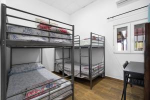 a bedroom with two bunk beds and a desk at Villa Pastrana in Chipiona +23 photos
