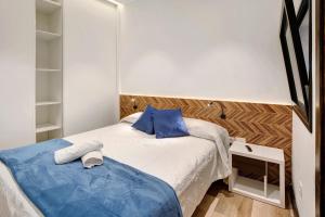 a small bedroom with a bed with blue pillows at Casa Miranda 1 in Candelaria