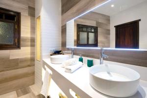 a bathroom with two sinks and two mirrors at Casa Miranda 1 in Candelaria +16 photos