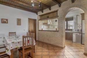 a kitchen with a table and a brick wall at Casa Carmelo 1 familas o parejas in Conil de la Frontera