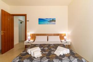 a bedroom with a large bed with two night stands at Ragusa 59 in Ragusa